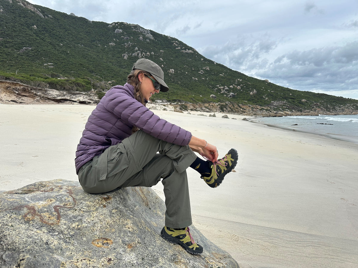 Archive Army Cap in khaki green, worn on a rock at the beach
